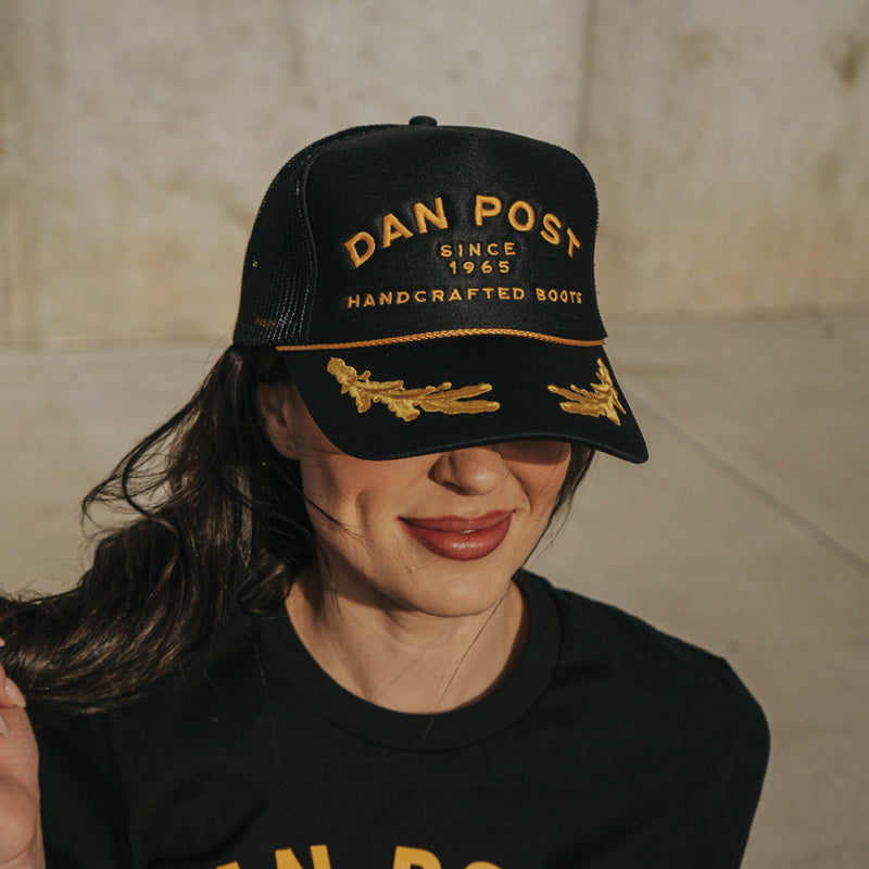 Woman wearing Dan Post hat.